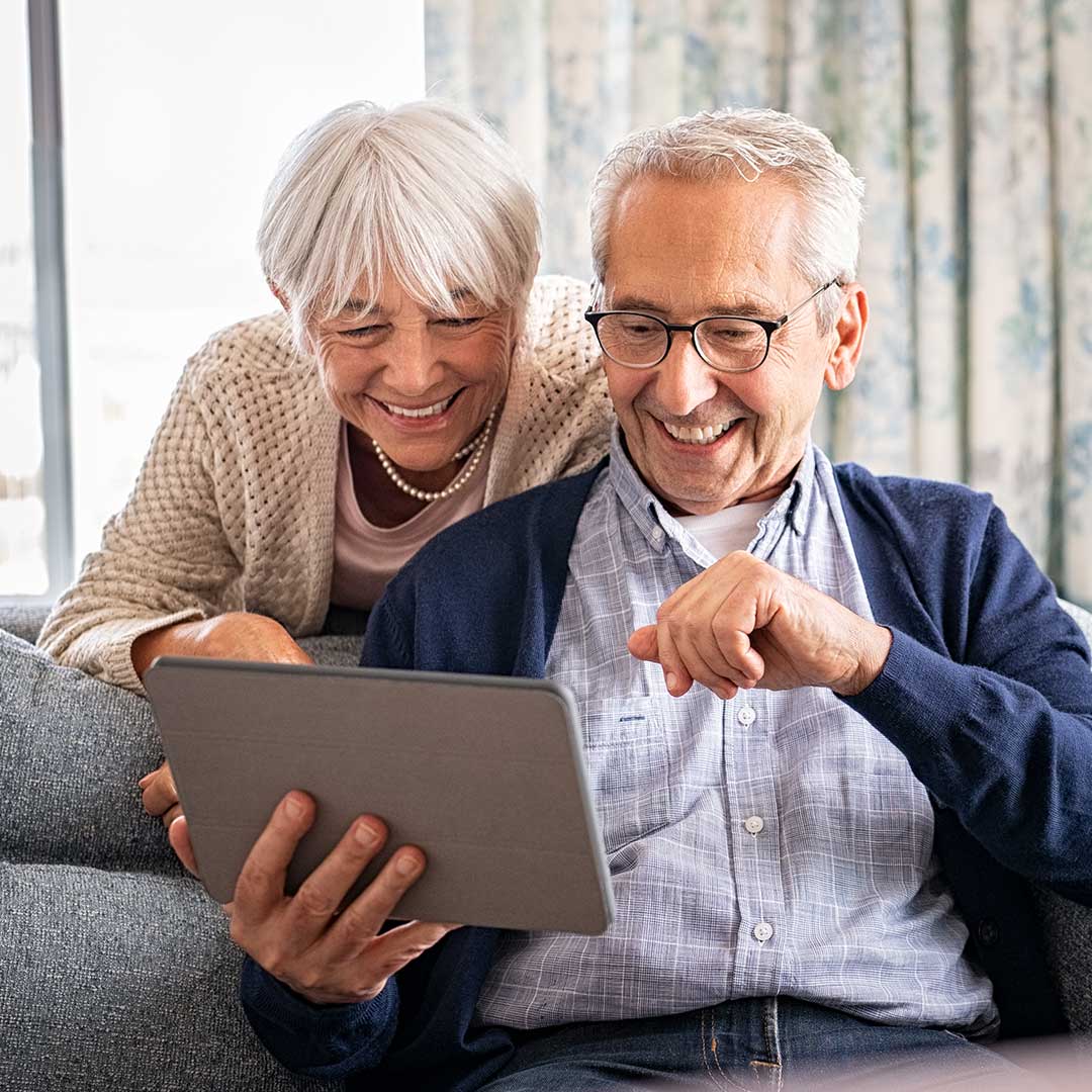 older couple looking at an ipad